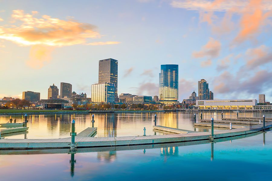 About Our Agency - City Skyline View of Milwaukee Wisconsin Against a Blue Sky at Sunset Next to the River